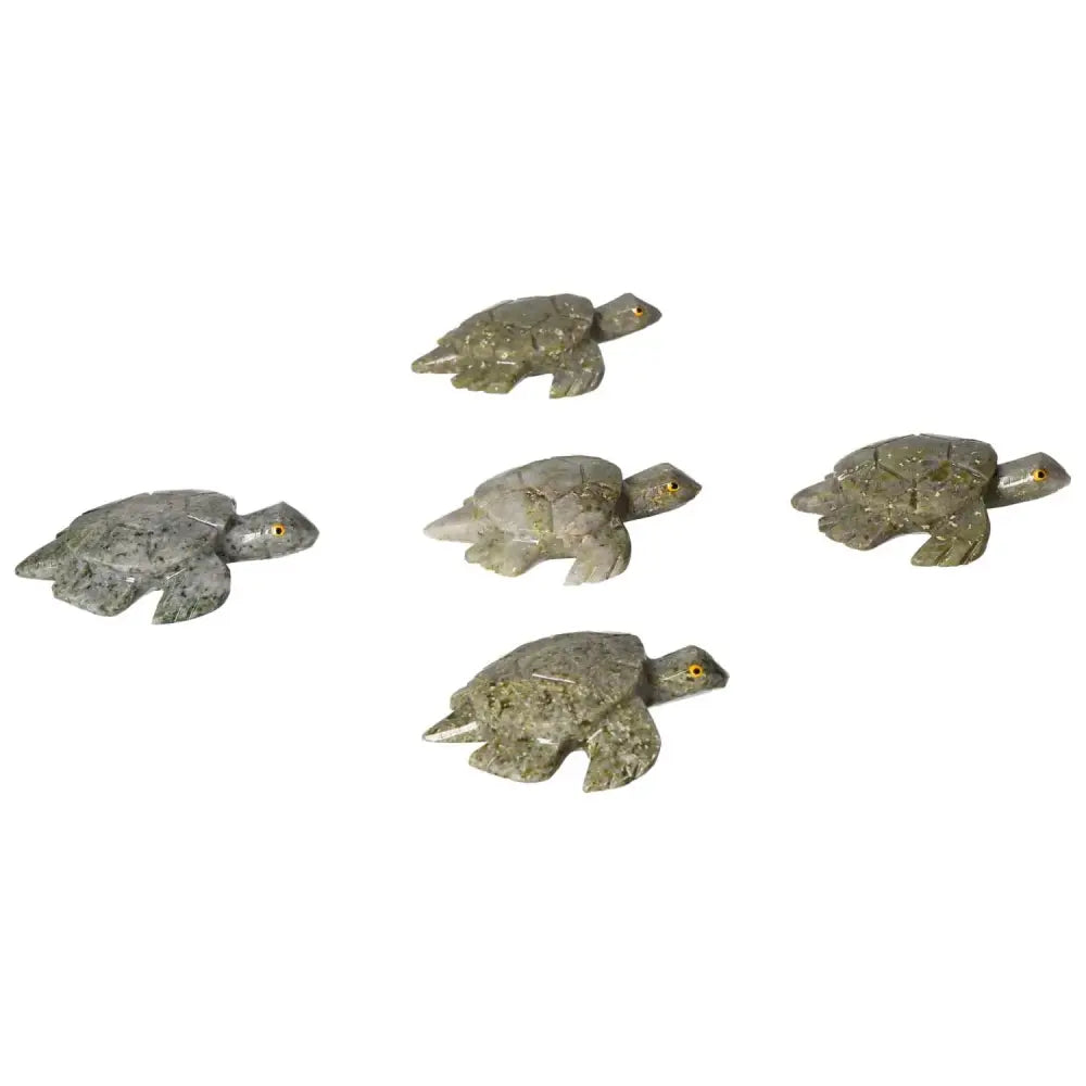 Five carved dolomite turtles displayed on a white surface, highlighting their intricate details and natural stone textures.