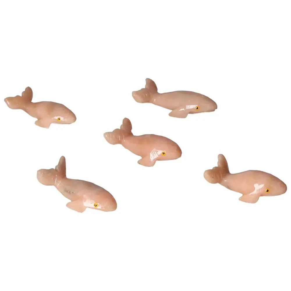 Handcrafted carved dolomite whale figurines from Sylvia Crystals, symbolizing tranquility and elegance in home decor.