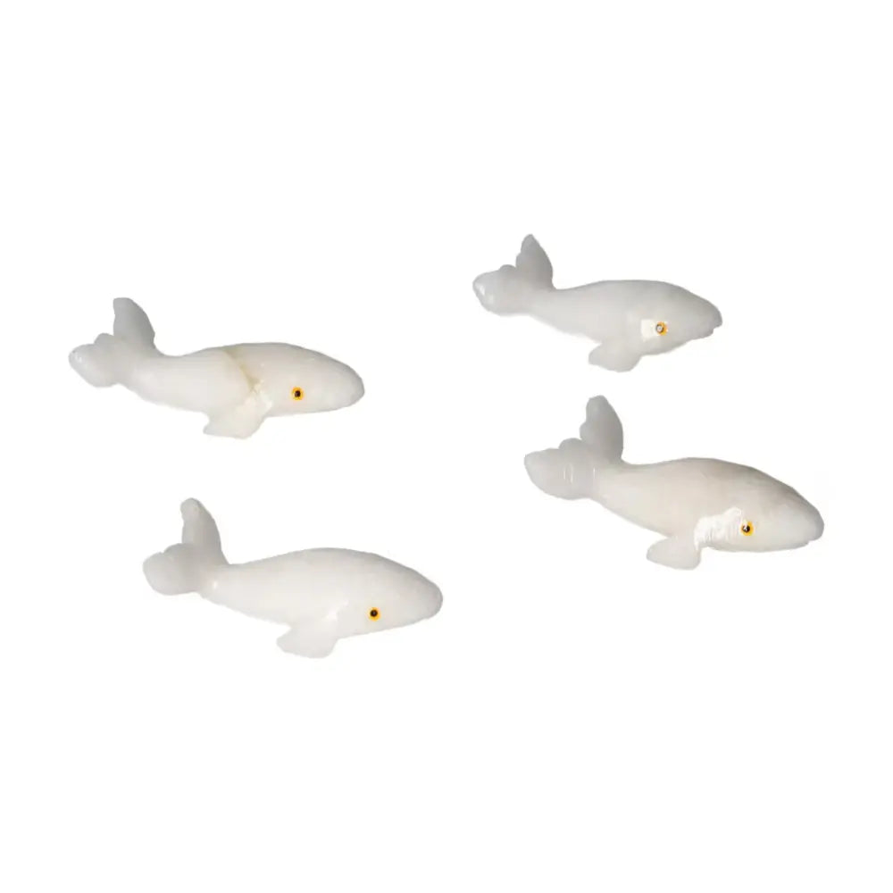 Handcrafted carved dolomite whale figurines symbolize peace and serenity, ideal for emotional balance and decorative use.