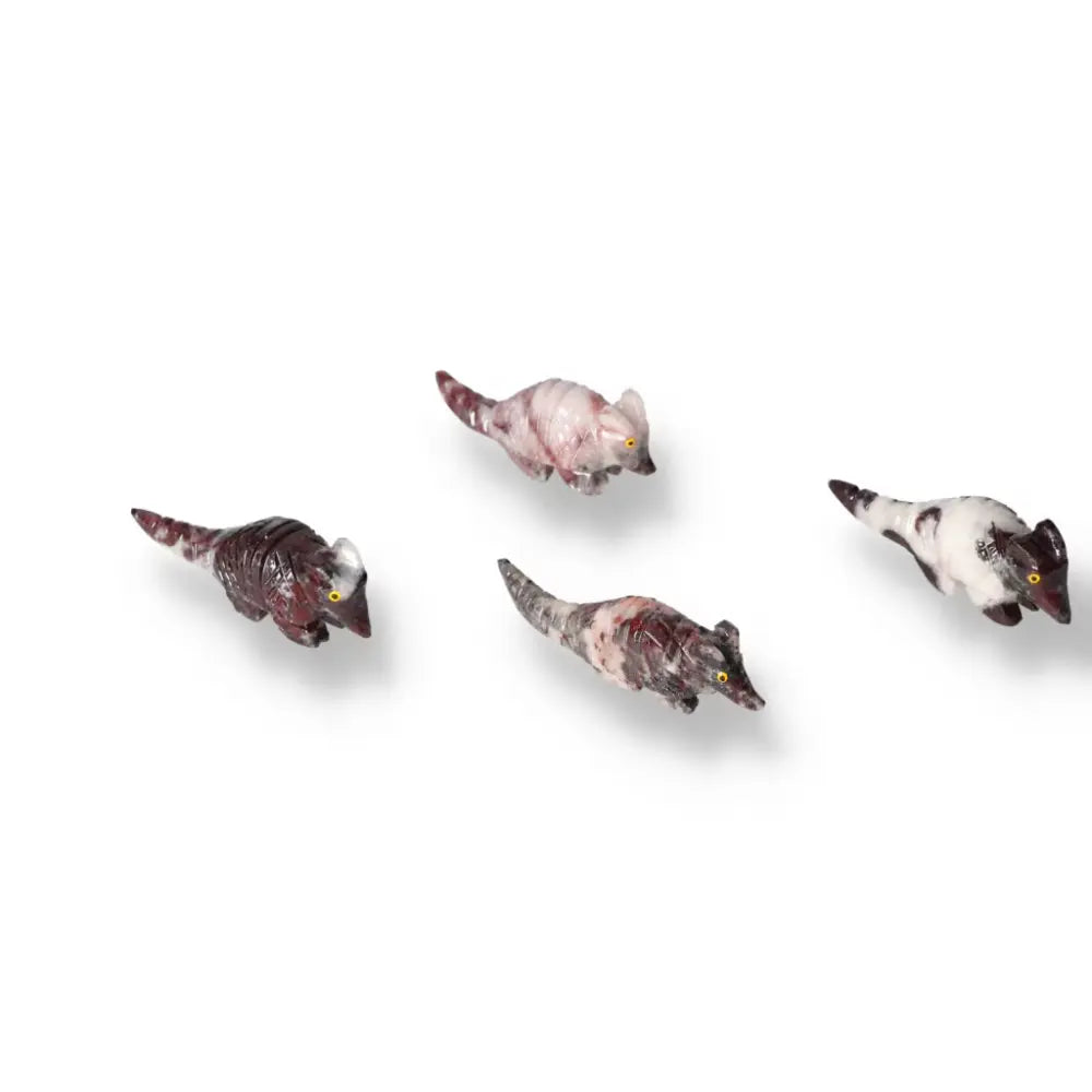 Four carved magnesite armadillo sculptures with varied patterns, renowned for their aesthetic beauty and spiritual tranquility from Sylvia Crystals.