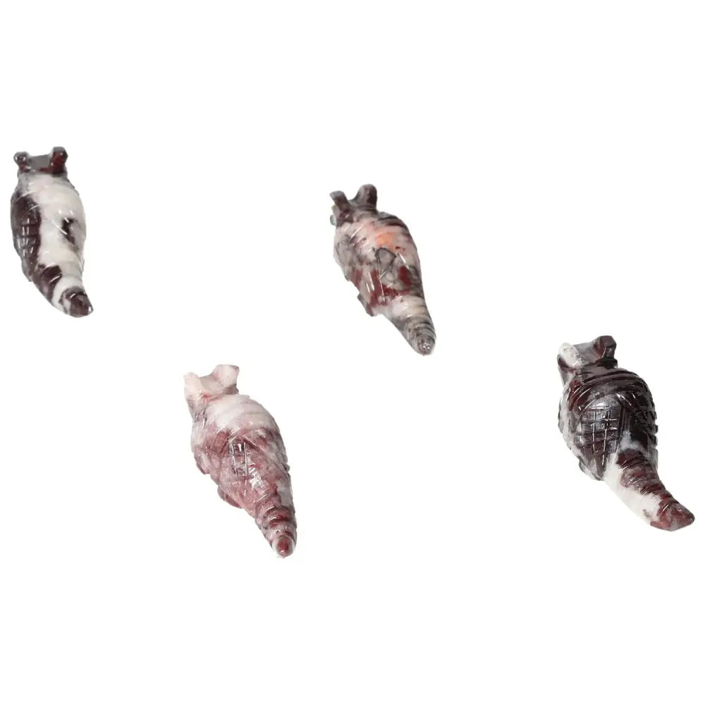 Four carved magnesite armadillo sculptures from Sylvia Crystals, showcasing unique patterns and spiritual properties.