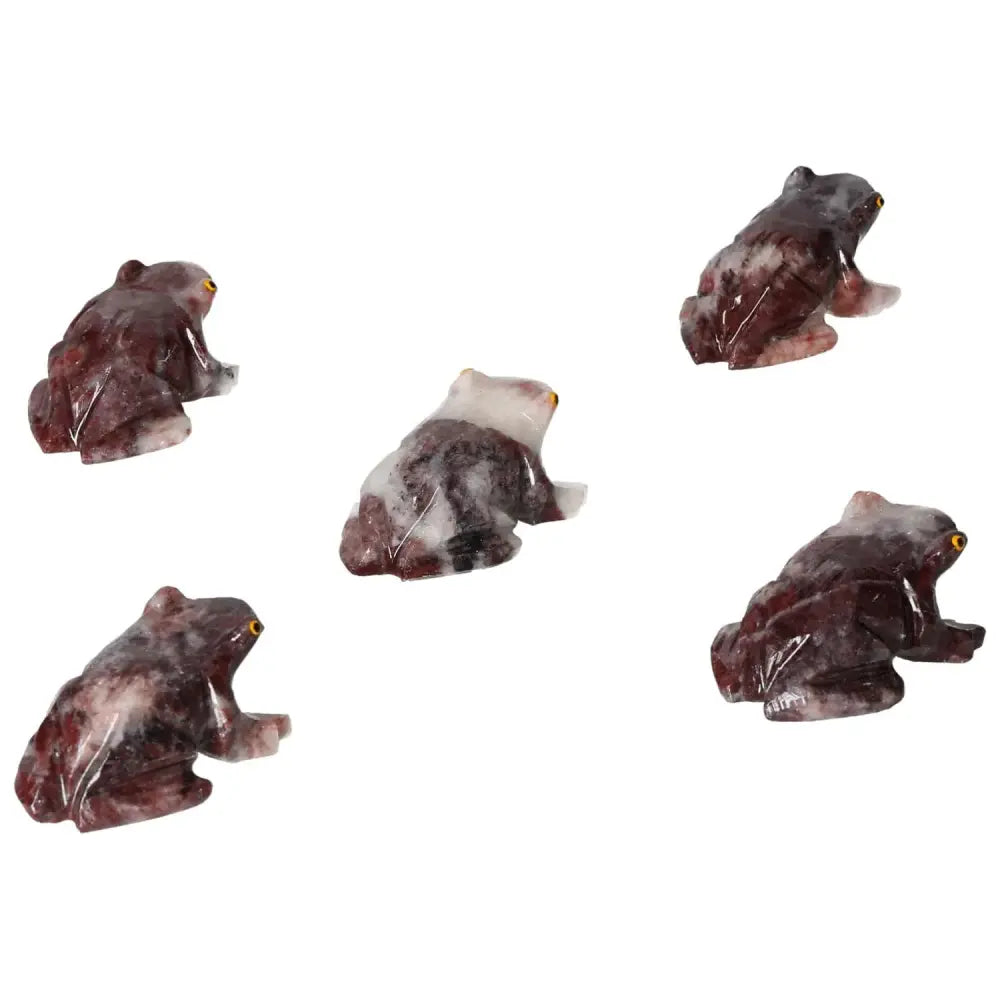 Five carved magnesite frog sculptures displayed on a white background, showcasing detailed craftsmanship and rich coloration.