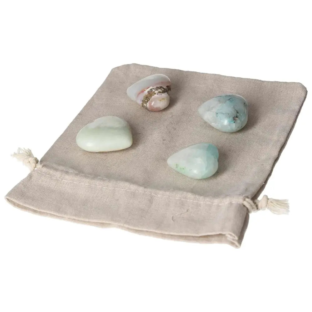 Chrysocolla heart-shaped stones with powerful feminine energy, perfect for enhancing communication and understanding emotions, displayed on a cloth bag.