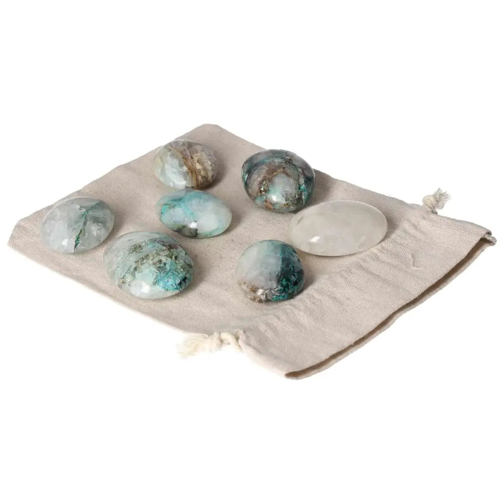 Chrysocolla palmstone set on linen pouch, showcasing vibrant blue-green shades and polished finish, ideal for enhancing communication skills.