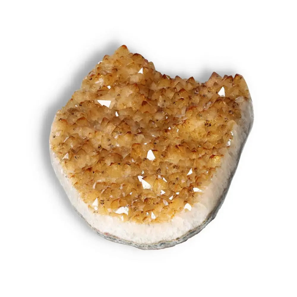 Glistening Citrine Druze crystal from Sylvia Crystals, symbolizing luxury and positivity, on a white background.