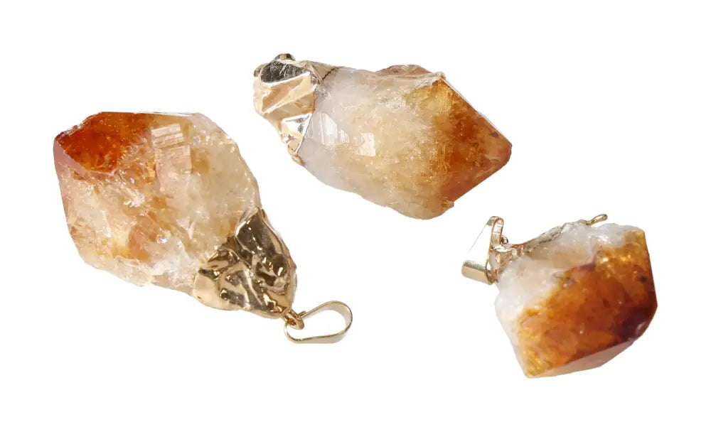 Citrine point pendants in medium size with gold caps, featuring a warm, earthy hue, ideal for elegant jewelry collections.