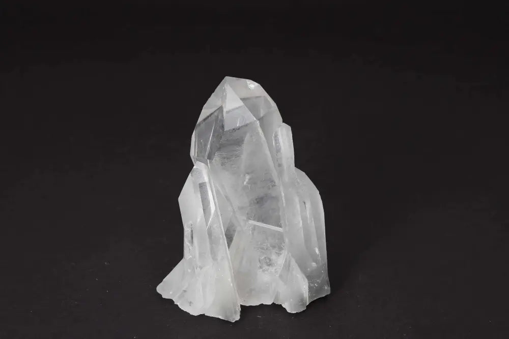 Clear Quartz Cluster on black background, showcasing multiple crystal points and pure energy, ideal for amplifying intention and purifying space.