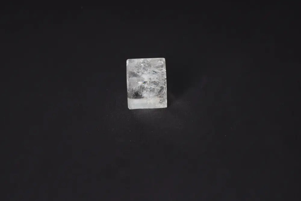 Clear Quartz Cube 3.5 cm on dark background, used for purification and harmonizing energy; neutralizes negative vibrations and radiation.