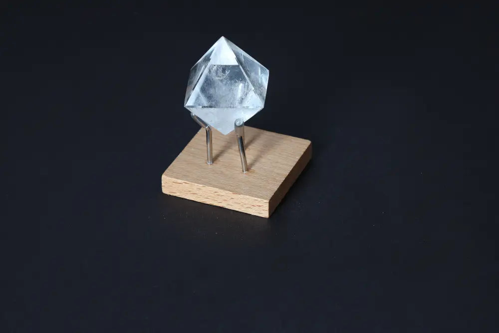 Clear Quartz Double Pyramid on wooden stand, ideal for harmonizing energy and neutralizing negative vibrations. 3 cm crystal.