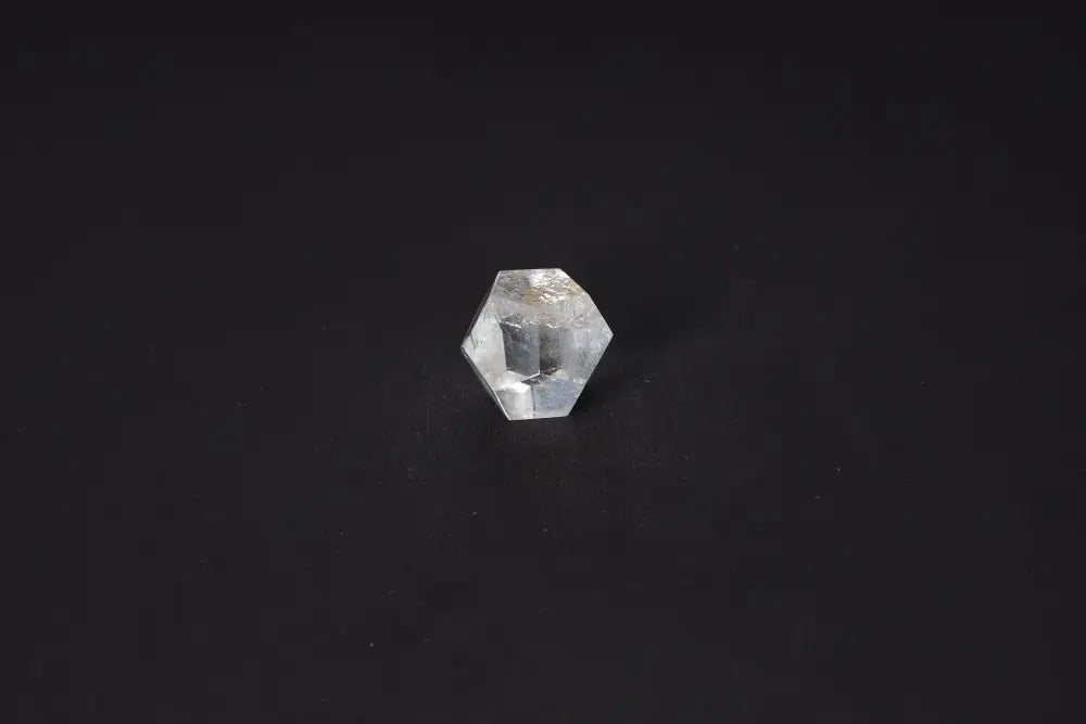 Clear Quartz Geometric Sphere 3 cm stone for positive energy and purification against negative vibrations on a dark background.