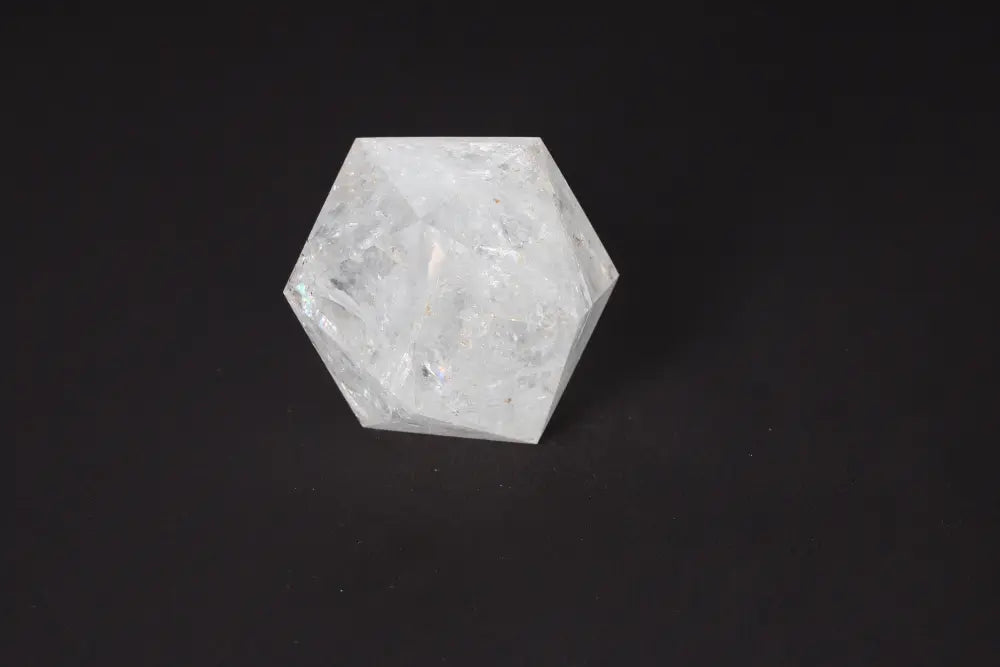 Clear Quartz Geometric Sphere 8 cm on black background, known for purification and energy harmonization.