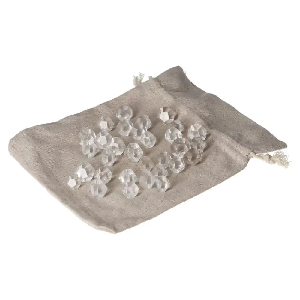 Small clear quartz geometric spheres on linen pouch for purification and energy harmonizing.