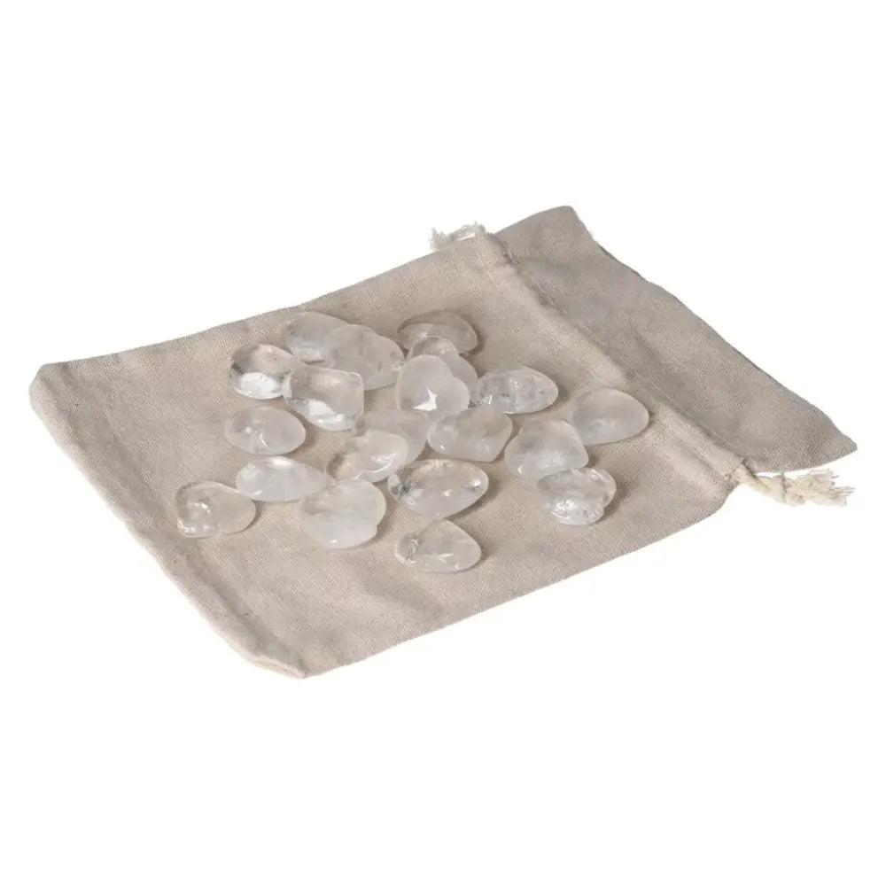 Clear Quartz Small Hearts on beige cloth, offering purification, harmony, and EMF protection. Ideal for meditation and emotional balance.