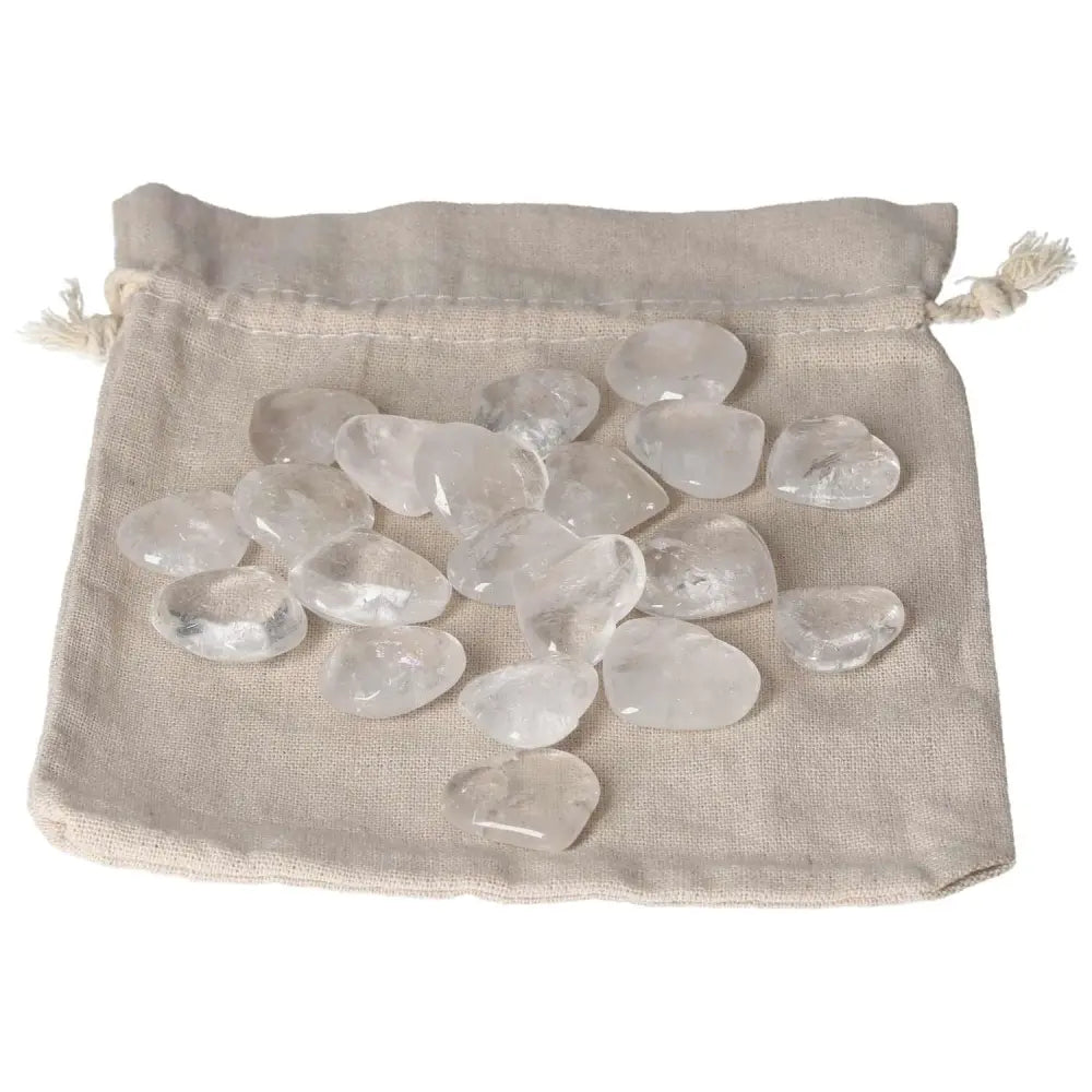 Clear Quartz small hearts on a beige cloth pouch, ideal for purification and harmonizing energy in any space.