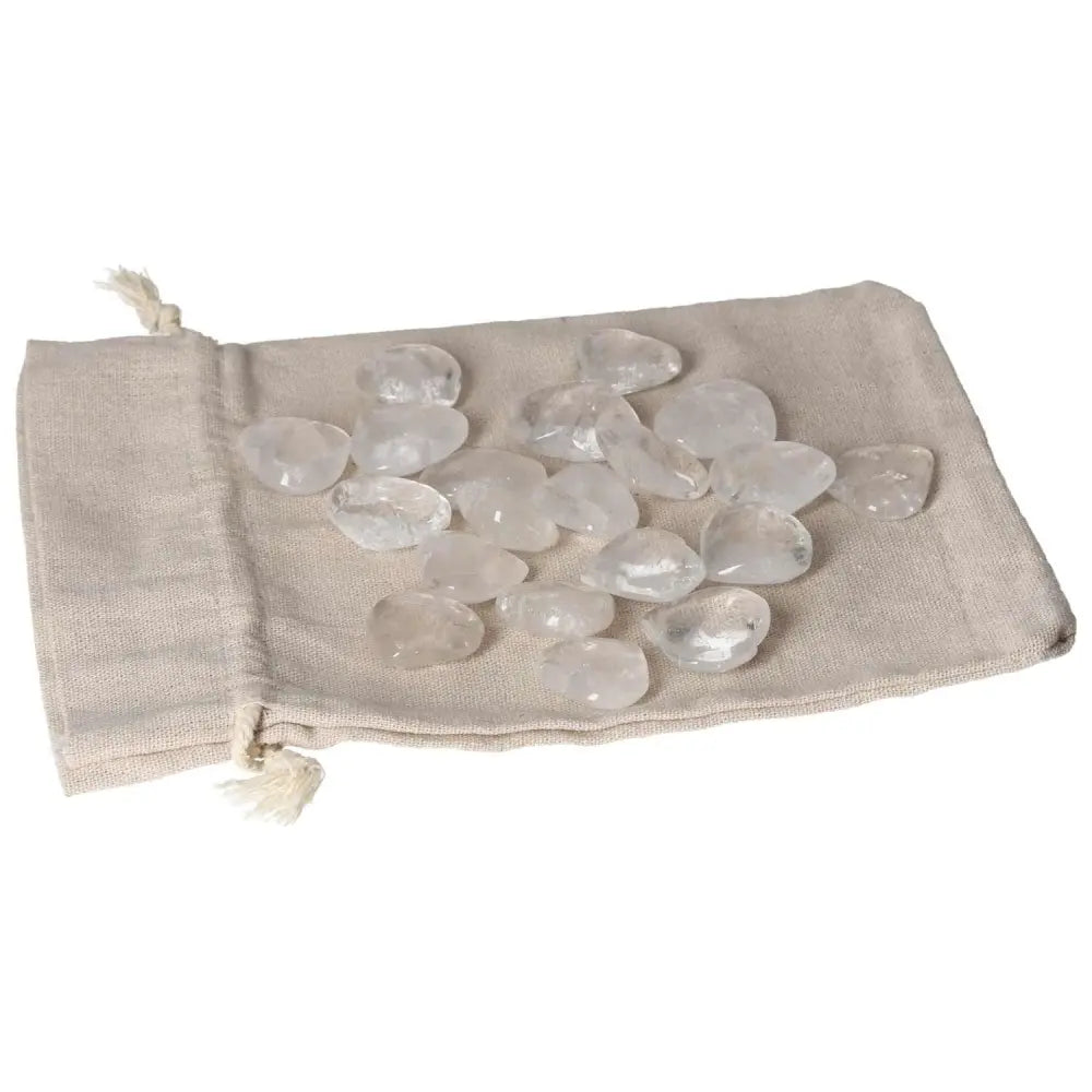 Clear Quartz Small Heart stones on a beige cloth pouch, known for purifying and harmonizing energy, ideal for everyday use.