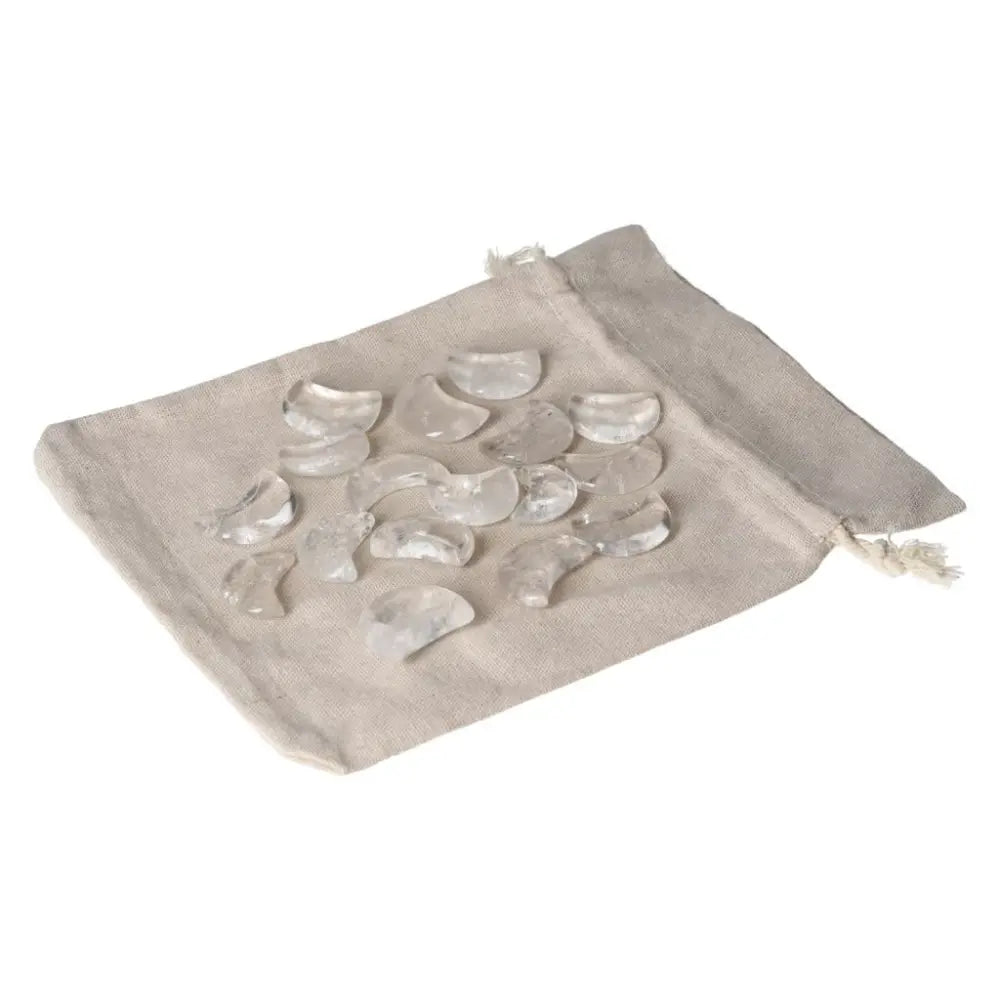 Clear Quartz Small Moon stones on a beige pouch, perfect for energy harmonization and purification, absorbing negative vibrations.