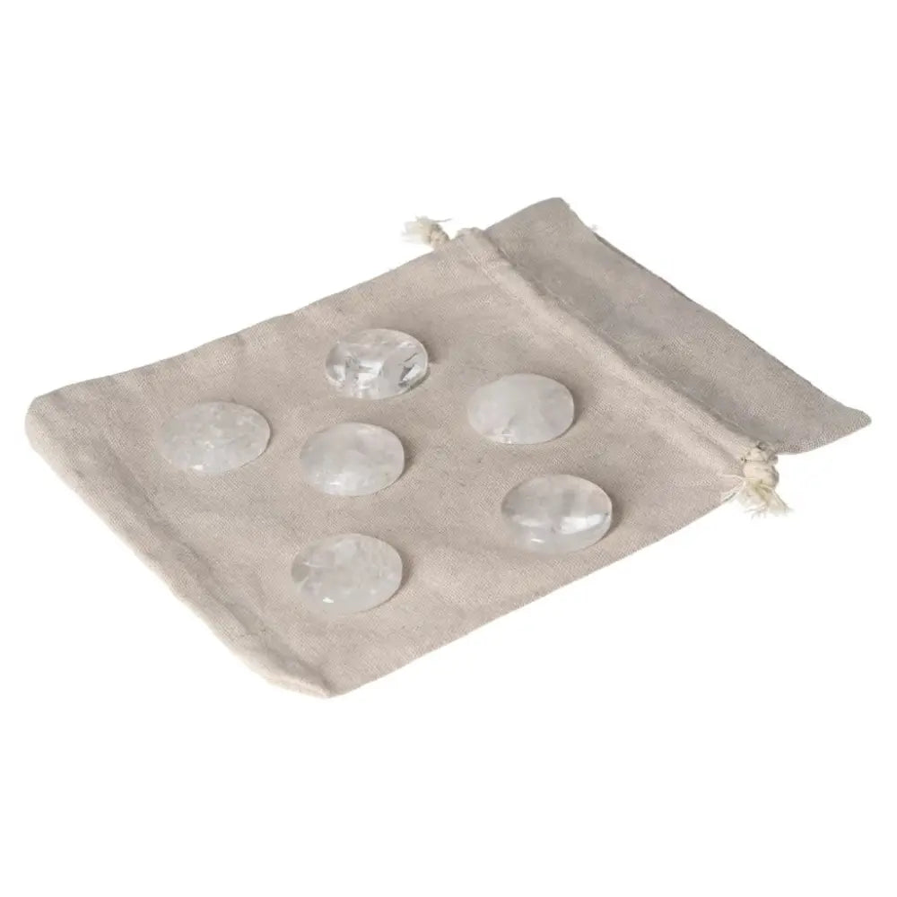 Clear Quartz small palmstones in a linen pouch, ideal for harmonizing energy and purifying spaces.