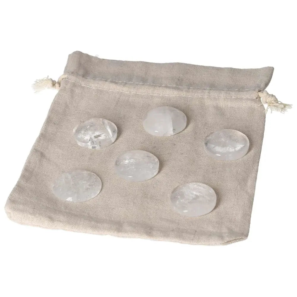 Clear quartz small palmstones on a drawstring cloth bag for energy purification and harmonizing the mind and space.