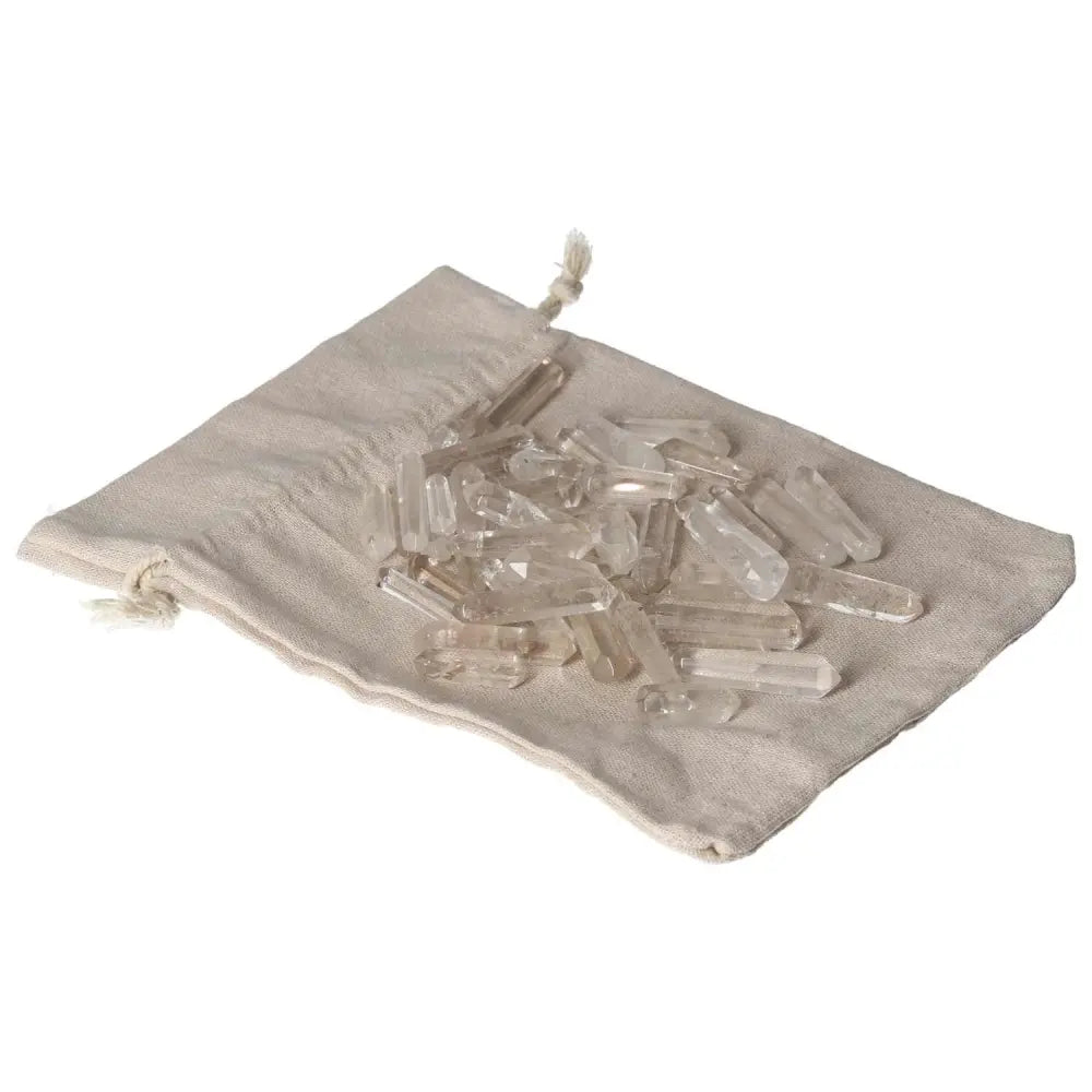 Clear Quartz Small Sticks on a linen pouch, used for purification and harmonizing energy, dispelling negative vibrations and emotions.