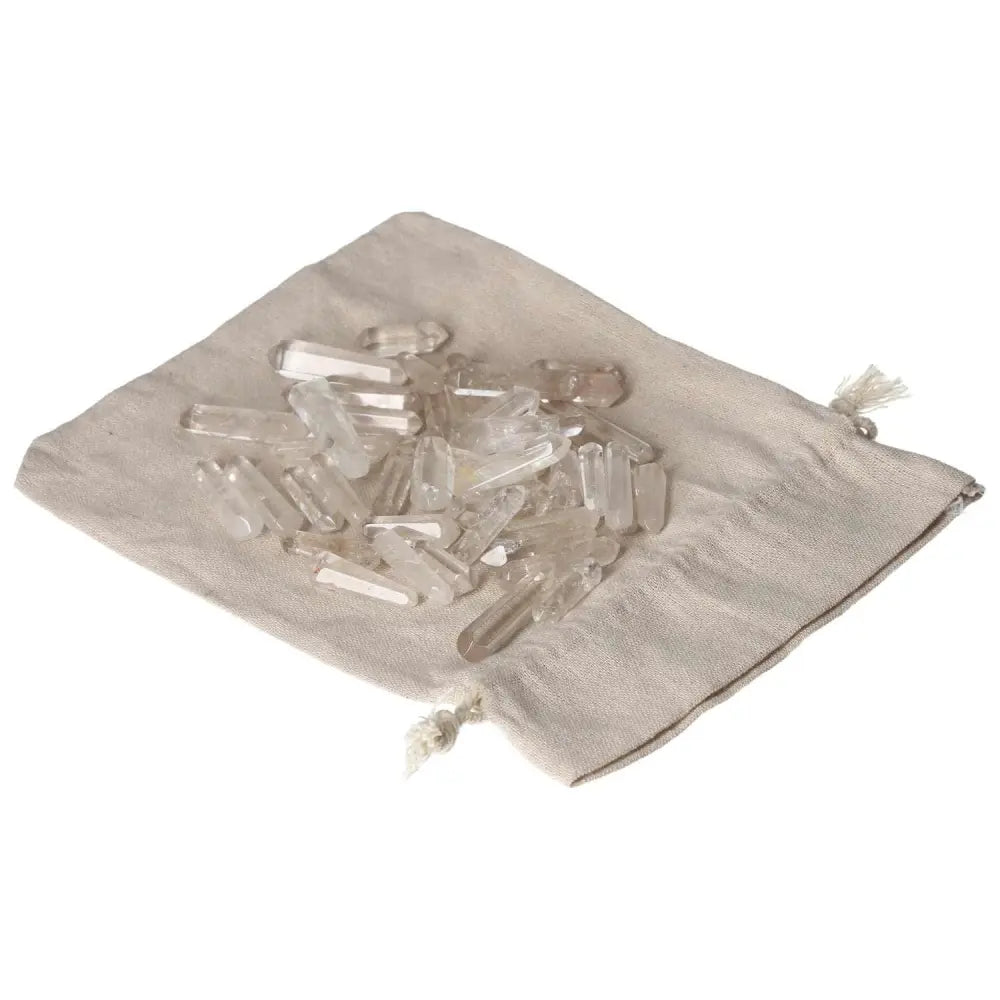 Clear Quartz Small Stics on a fabric pouch, ideal for purification, harmonizing energy, and neutralizing negative vibrations.