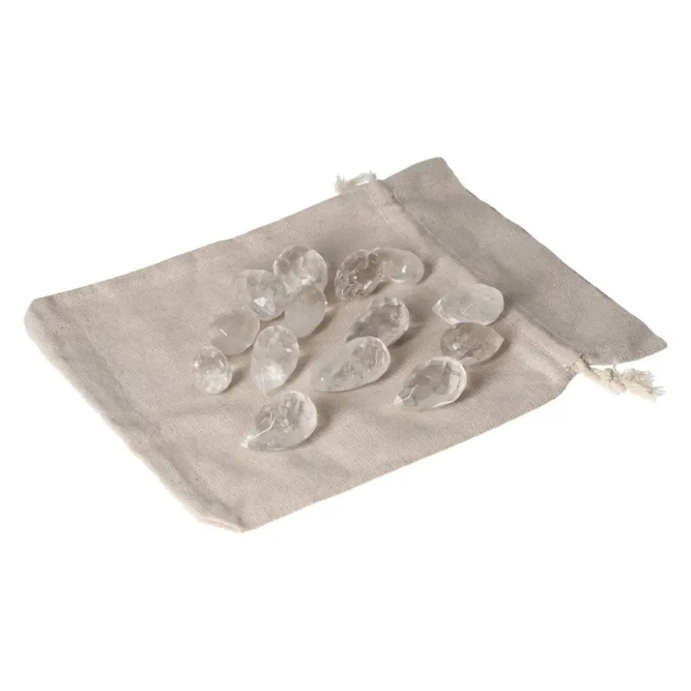 Clear Quartz small tear stones on a beige pouch, ideal for energy purification and harmonizing body and mind.
