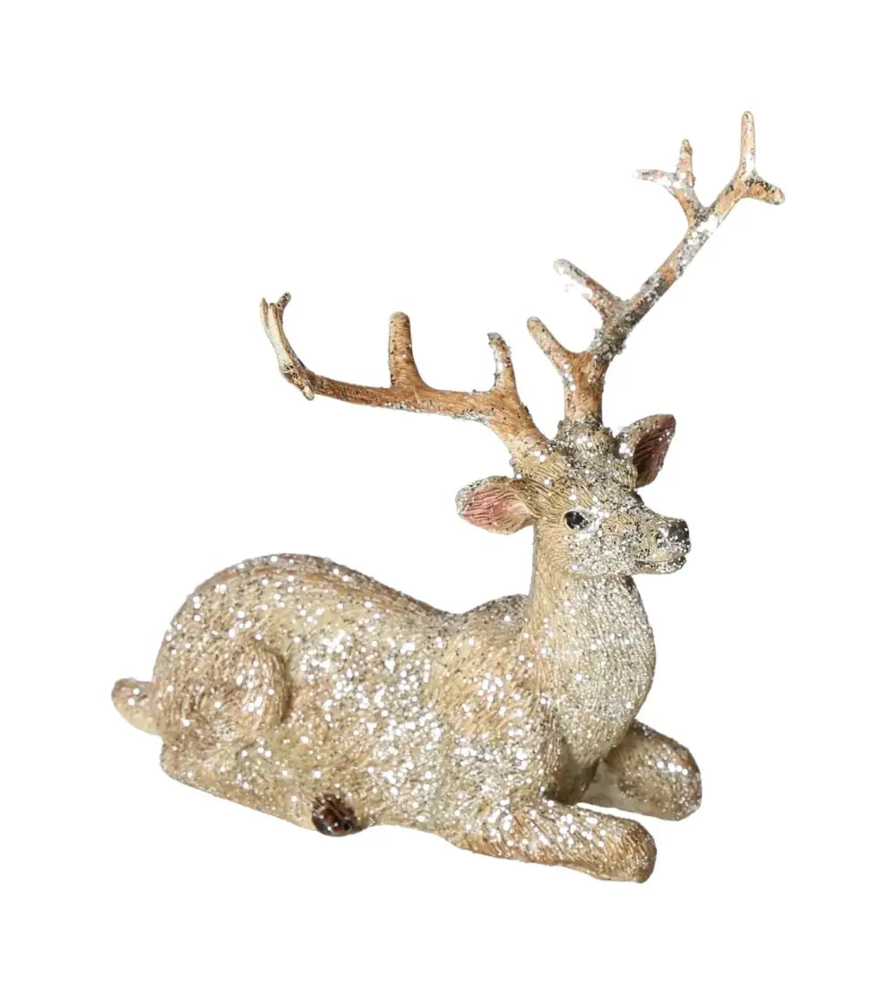 Elegantly crafted deer figurine with shimmering glitter, lying in repose. Made of high-quality polyresin for sophisticated decor.
