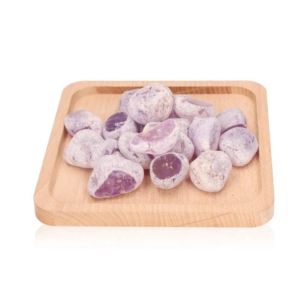 Smooth purple Emma Eggs river stones on a wooden tray, ideal for promoting balance and harmony.