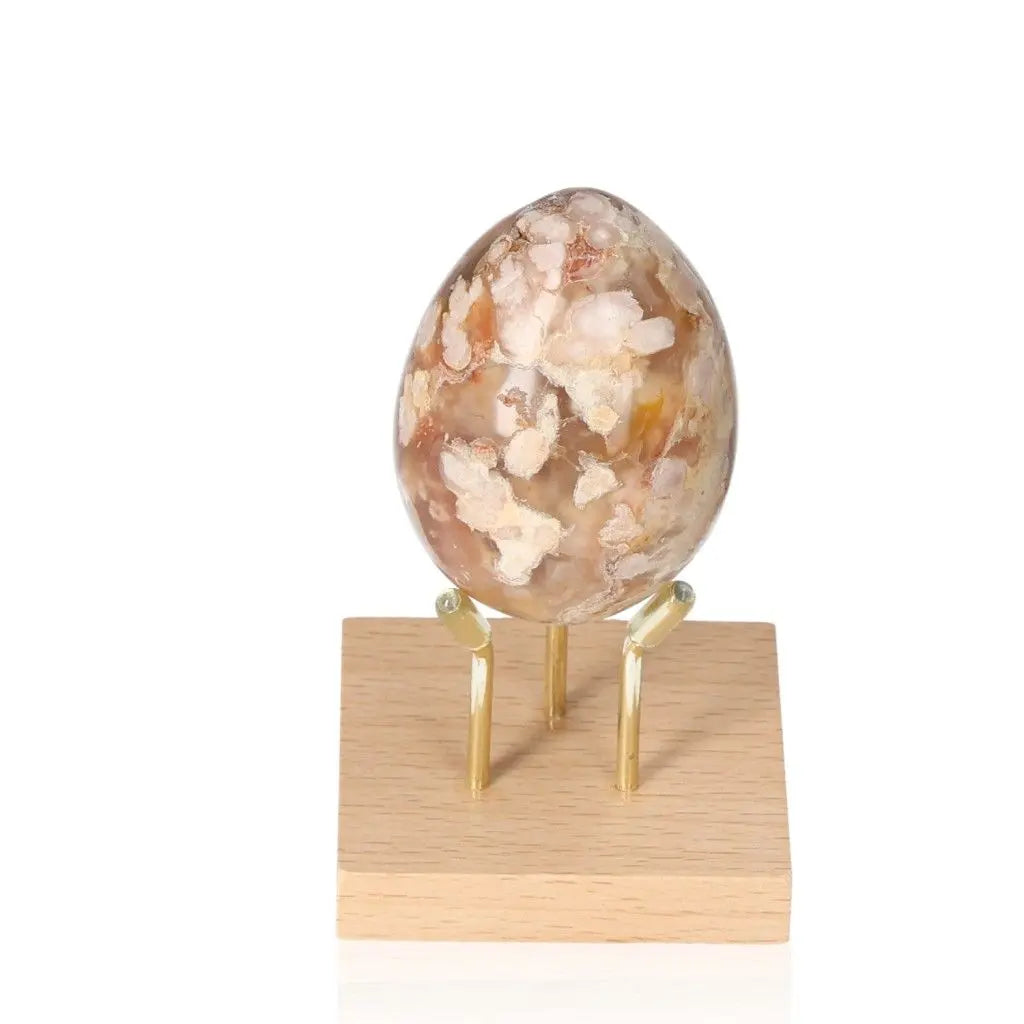 Flower Agate Egg on wooden stand with blossom-like patterns, ideal for promoting growth, healing, and positive energy.