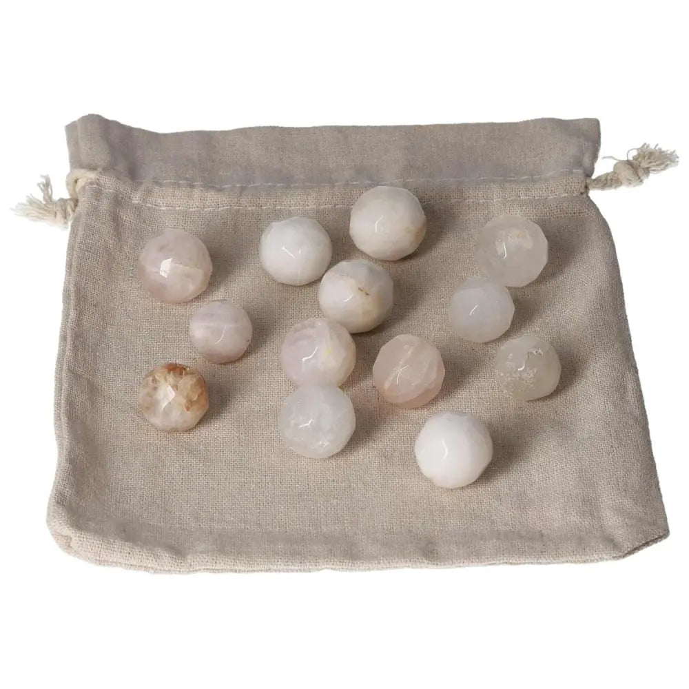 Golden Healer small geometric spheres displayed on a natural fabric pouch