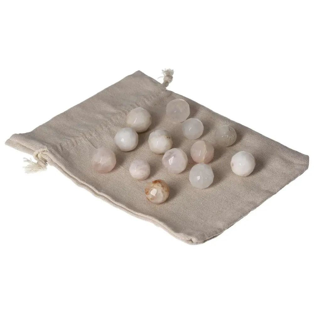 Collection of small geometric Golden Healer spheres laid on a beige fabric pouch.