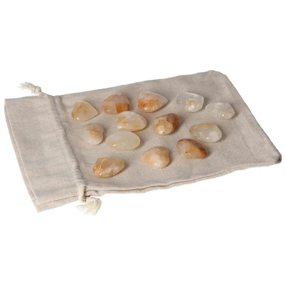 Golden Healer small heart stones on a beige pouch, ideal for healing and wellness practices.