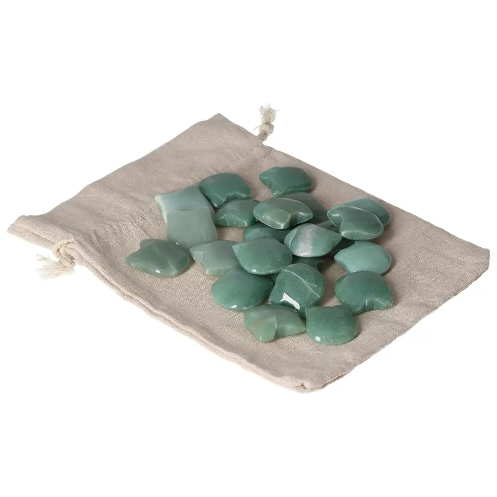 Green Aventurine stones on a beige drawstring pouch, symbolizing luck, prosperity, and calming energy for positive life changes.