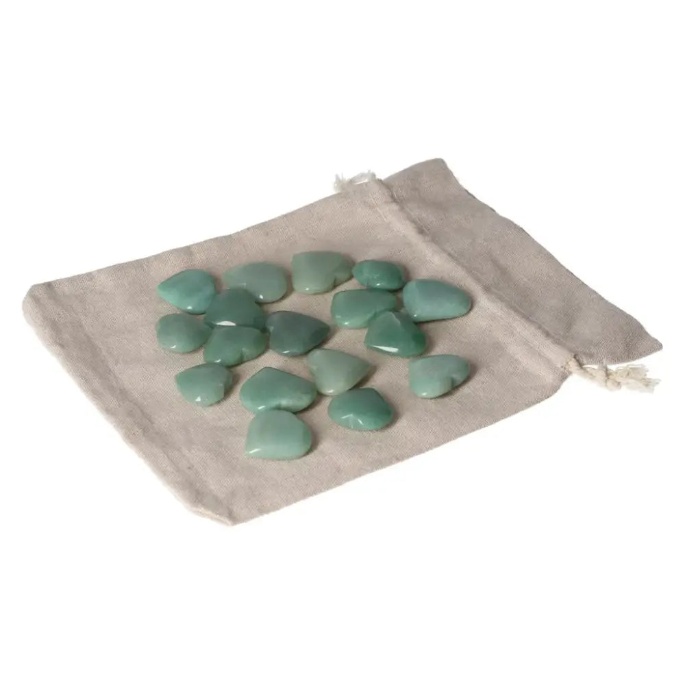 Green Aventurine small heart stones on a beige pouch, symbolizing luck, prosperity, and inner peace with calming properties.