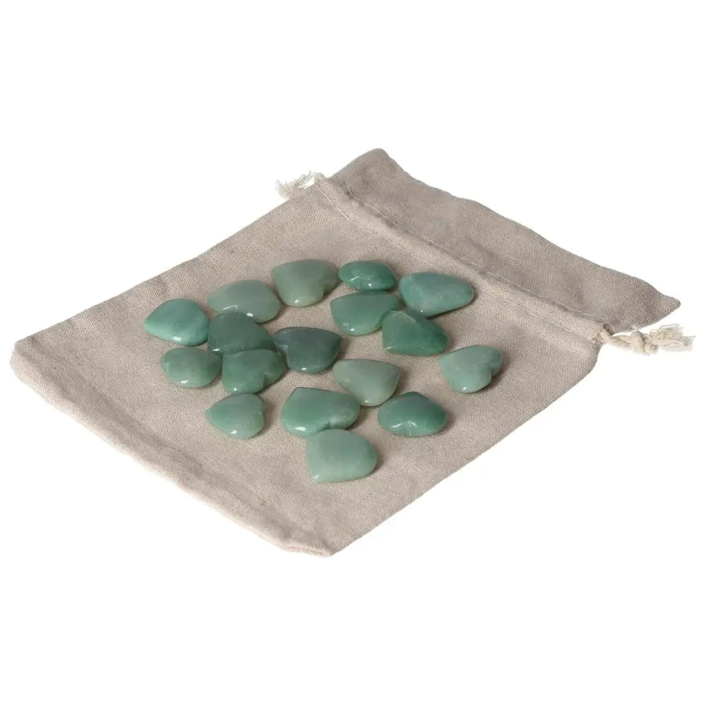 Green Aventurine small heart stones on a linen pouch, symbolizing luck, prosperity, and inner peace.