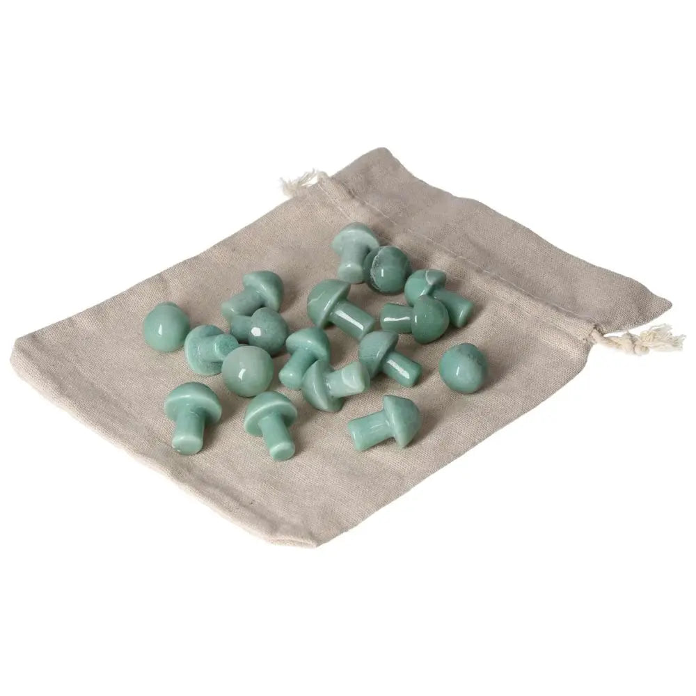 Small green aventurine mushroom stones on a beige pouch, promoting luck, harmony, and self-confidence in new ventures.