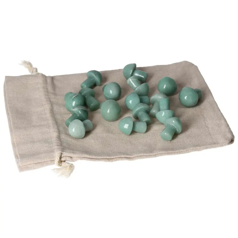 Green Aventurine small mushroom stones on a beige fabric pouch, promoting luck, prosperity, and self-confidence.