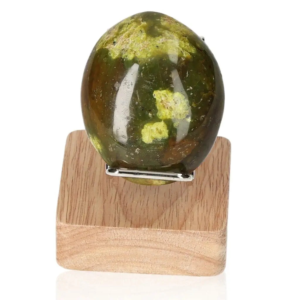 Green Opal Freeform gemstone on wooden stand, symbolizing renewal, healing, and emotional balance with soothing green hues.