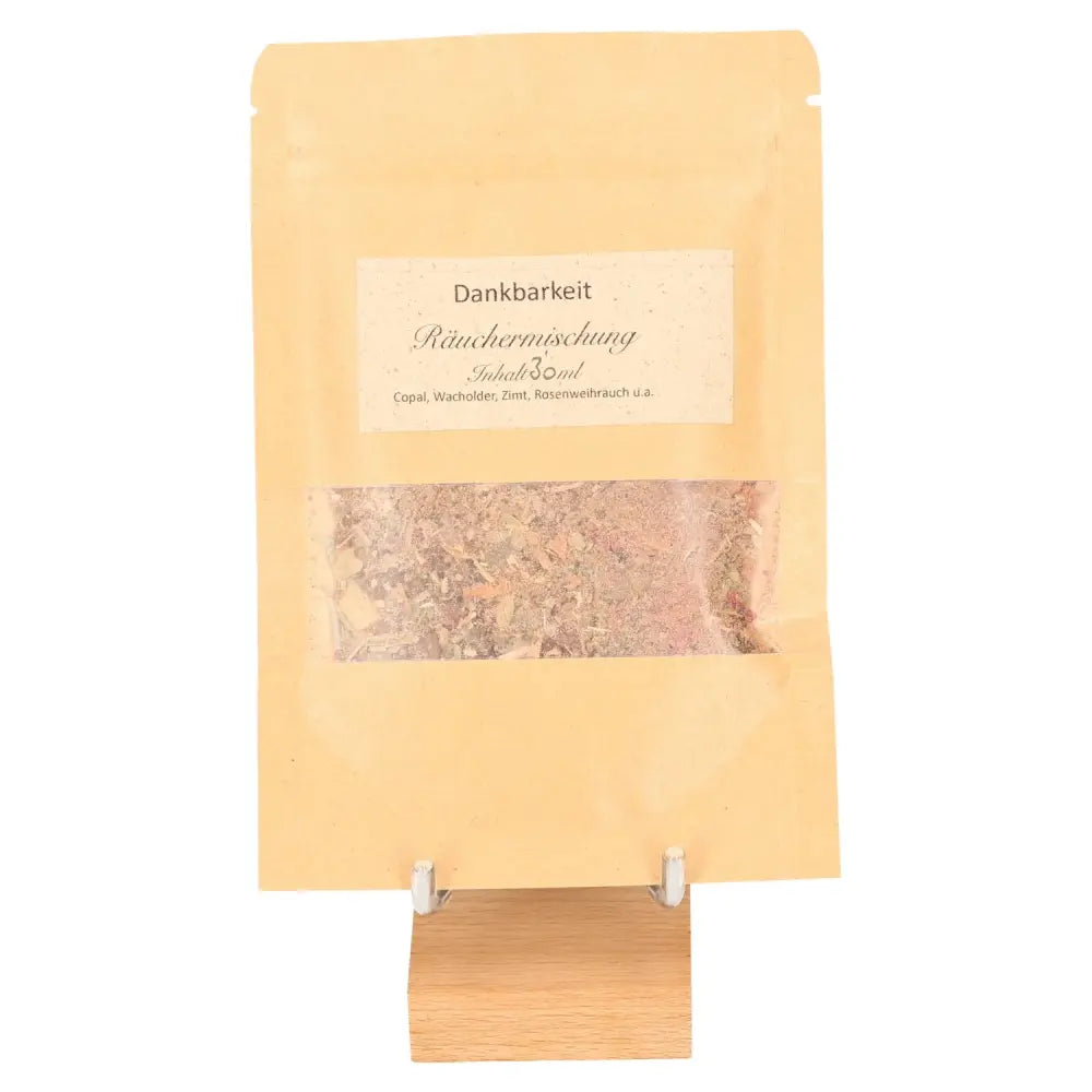 Incense Blend 'Thanksgiving' for gratitude and reflection, packaged in a rustic brown pouch on a wooden stand.
