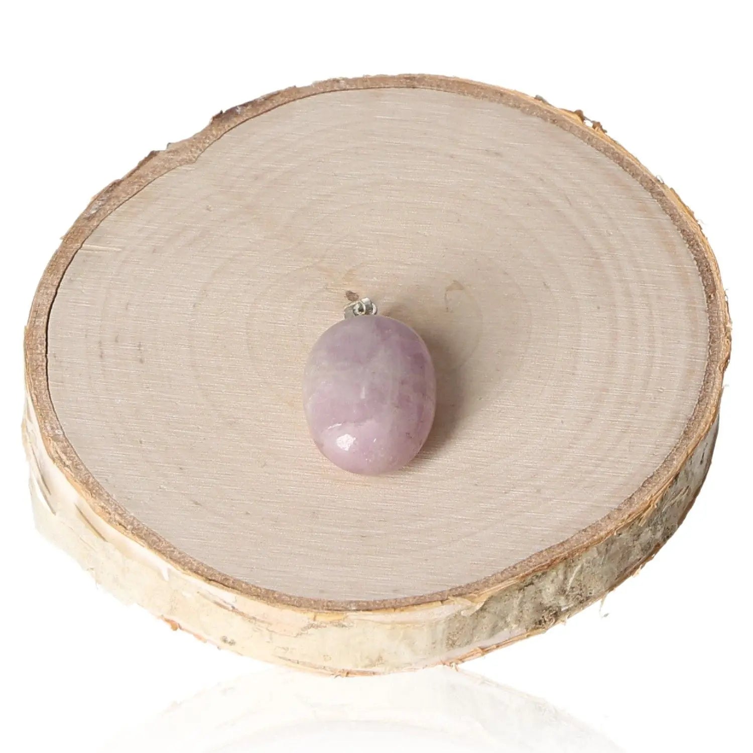 Kunzite Tumbled Pendant with a gentle pink hue, displayed on a wooden base, showcasing its calming and elegant qualities.