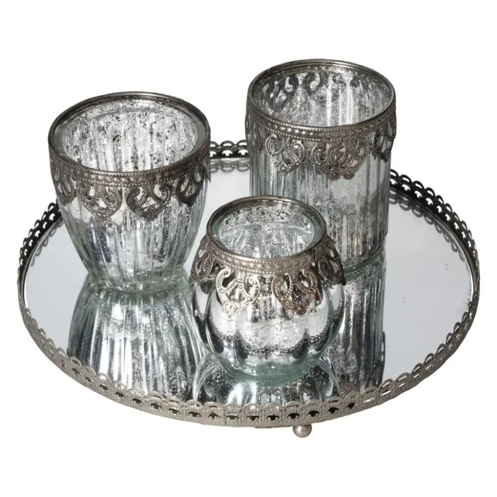 Lantern set on mirrored tray with silver metal trim, featuring intricate design. Premium home decor by Sylvia Crystals for elegance.