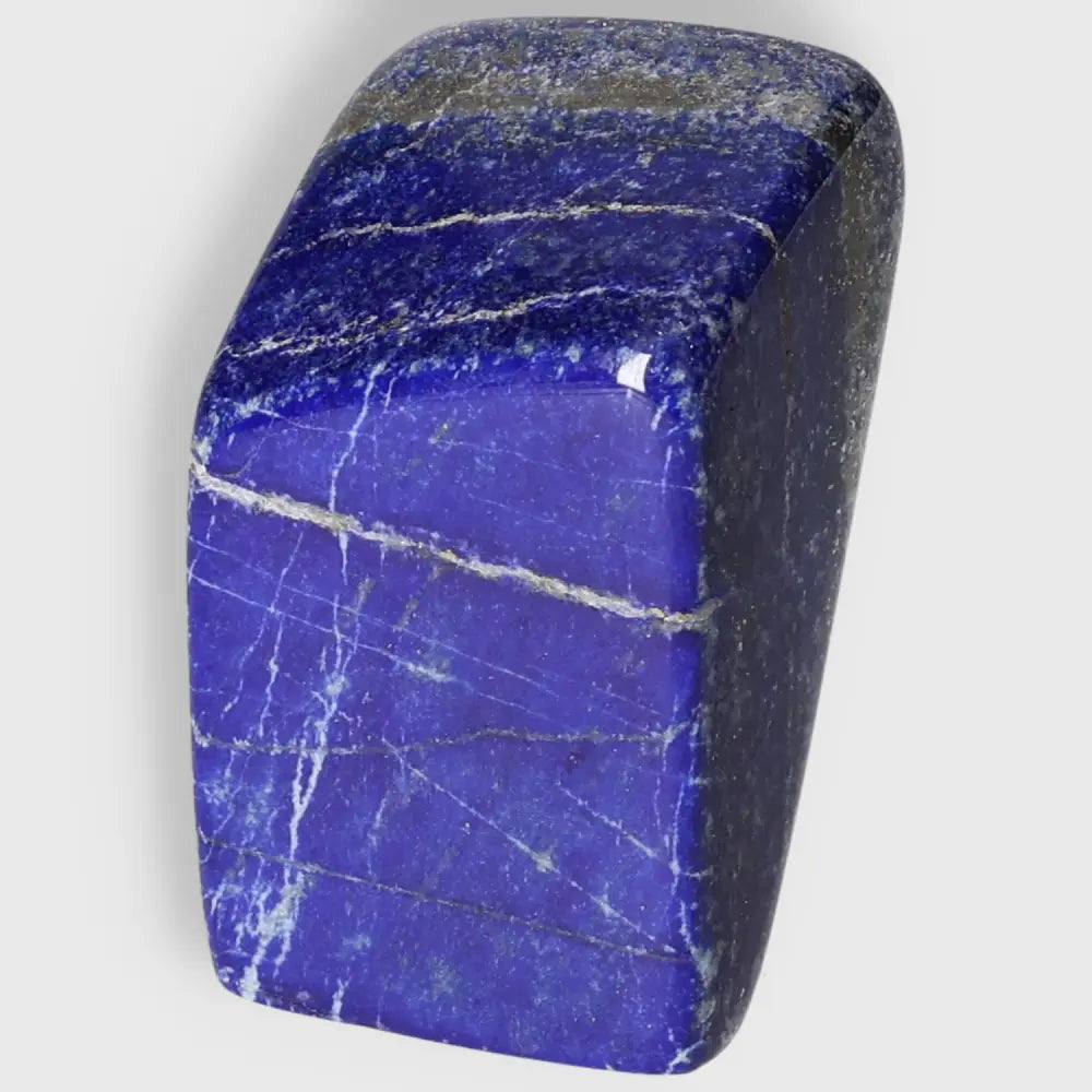 Lapis Lazuli Obelisk with deep blue and golden pyrite flecks, perfect for home décor and enhancing energy, sourced from Pakistan.