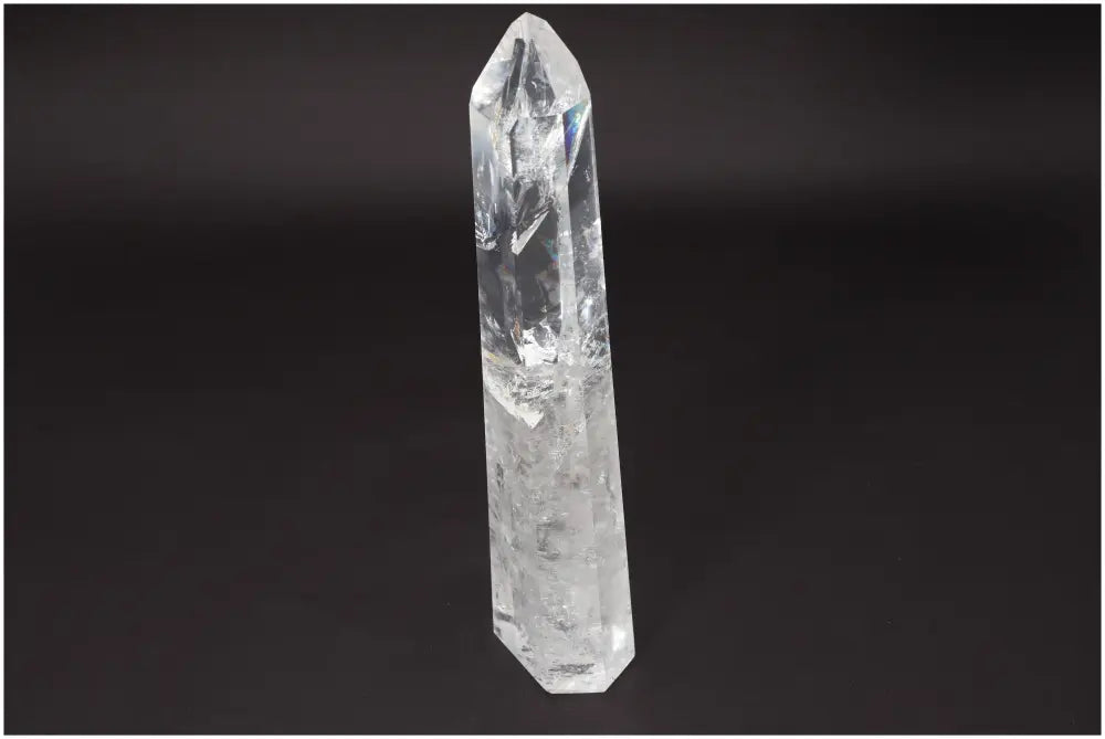 Large Lemurian Clear Quartz Obelisk for clarity and balance on a black background. Ethically sourced and hand-selected crystal.