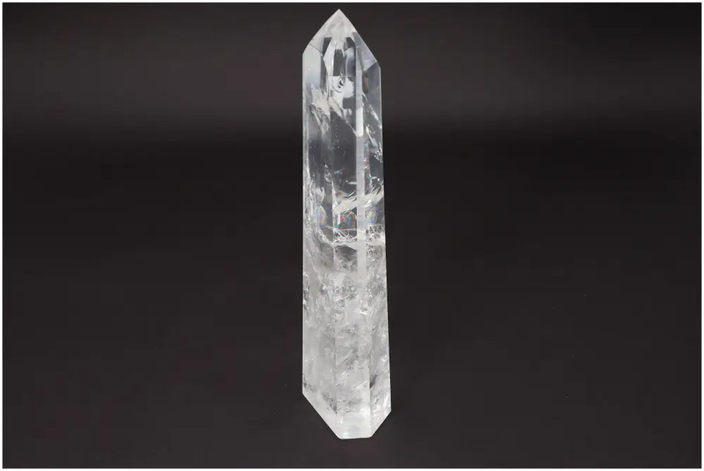 Elegant Large Lemurian Quartz Obelisk crystal, known for clarity and energy amplification, against a dark background.