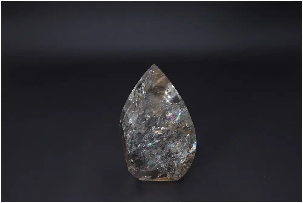 Large Lemurian Quartz Obelisk on a dark background, highlighting its natural clarity and unique structure.