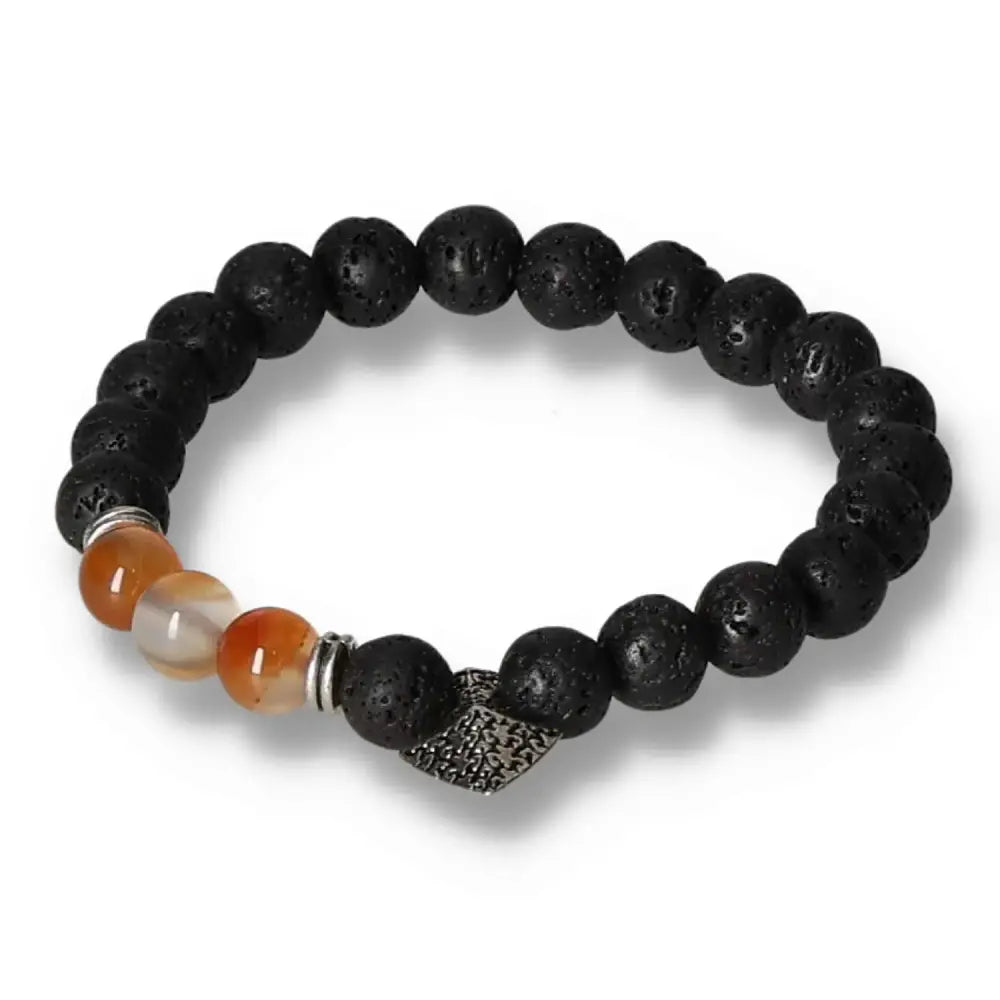 Lava stone bracelet with axe-head carnelian centerpiece, designed by Sylvia Crystals, showcasing rugged black stones and vibrant orange accents.