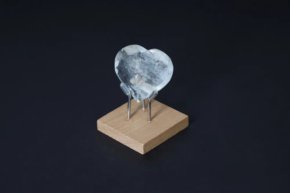 Lemurian Quartz Geometric Heart on stand, showcasing luxury and purity. Handcrafted clear quartz for spiritual harmony.