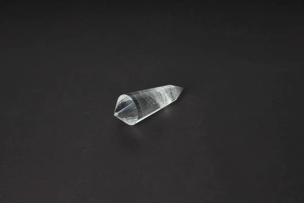 Exquisite Lemurian Quartz Point displaying ancient wisdom with distinct horizontal striations on a dark background.