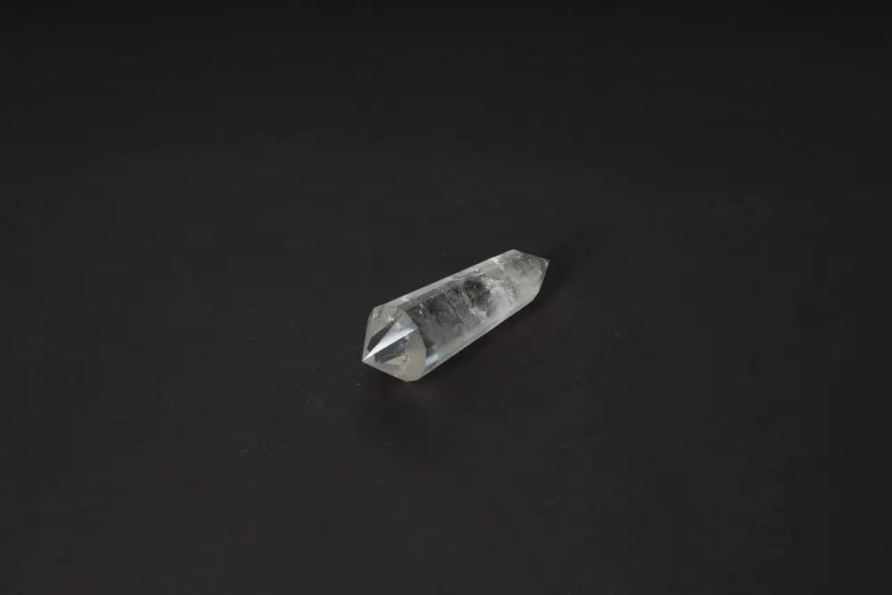 Lemurian Quartz Point with distinct striations on a dark background, symbolizing ancient wisdom and spiritual harmony.