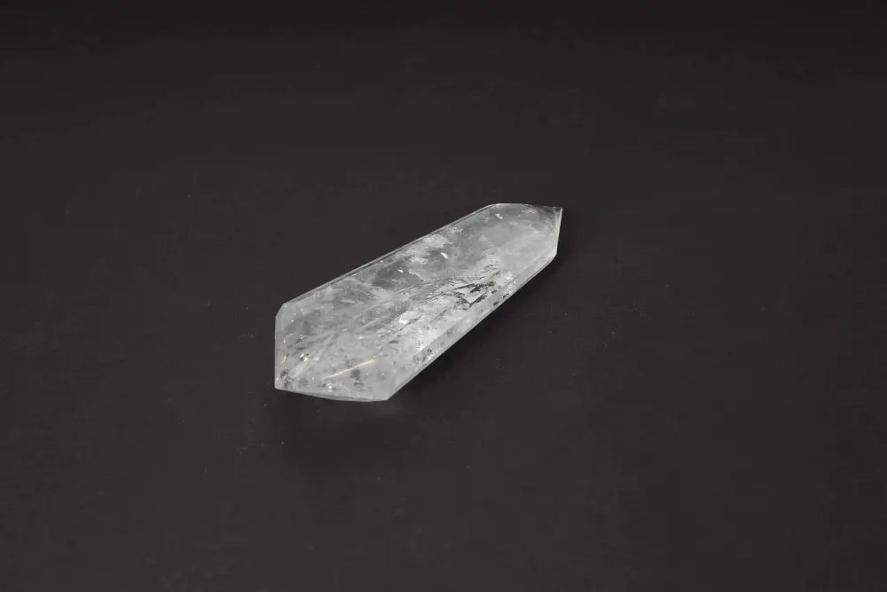 Lemurian Quartz Point crystal with ancient wisdom, featuring horizontal striations, against a dark background.