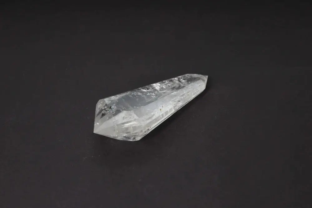 Lemurian Quartz Point with distinct striations, believed to carry Lemurian wisdom and ancient energies, displayed on a dark background.